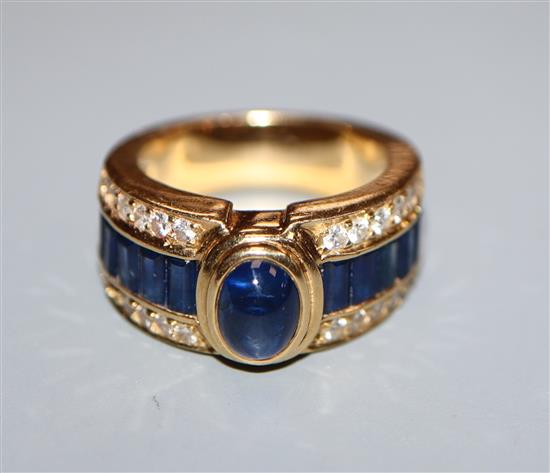 A modern 18k yellow metal, sapphire and diamond cluster dress ring, size J.